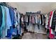 A functional walk-in closet with shelves, hanging racks, and organized storage solutions for clothing and shoes at 1546 Park Leah Cir, Apopka, FL 32712