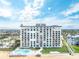 Aerial view showcasing the condo building, pool, beach access, and oceanfront location at 1575 Ocean Shore Blvd # 306, Ormond Beach, FL 32176