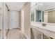 Well-lit hallway featuring a vanity area, closet, and entrance to other rooms at 1575 Ocean Shore Blvd # 306, Ormond Beach, FL 32176