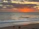 Beautiful sunrise view over the ocean with people on beach at 1575 Ocean Shore Blvd # 306, Ormond Beach, FL 32176