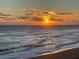 Stunning sunset over the ocean with golden light reflecting on the waves and sandy beach at 1575 Ocean Shore Blvd # 306, Ormond Beach, FL 32176