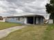 A single-story home with a blue exterior and a covered carport at 1606 26Th St, Orlando, FL 32805