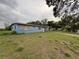 A view of the home's exterior and overgrown front lawn at 1606 26Th St, Orlando, FL 32805