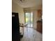 Image of kitchen featuring dark appliances and a door leading outside at 1606 26Th St, Orlando, FL 32805