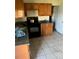 Kitchen featuring tile floors, wooden cabinets and a black stove top at 1606 26Th St, Orlando, FL 32805