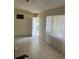 Open living room featuring tile floors, large window, and a front door at 1606 26Th St, Orlando, FL 32805