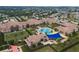 Aerial view of the community clubhouse and pool area, lush landscaping, and lounge areas at 172 Balmy Coast Rd, Groveland, FL 34736