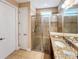 Bathroom featuring a tiled shower with glass door and granite countertops at 172 Balmy Coast Rd, Groveland, FL 34736