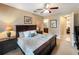 Serene bedroom featuring soft lighting, a ceiling fan, and access to an en-suite bathroom, offering a peaceful ambiance at 172 Balmy Coast Rd, Groveland, FL 34736