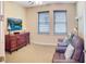 Bedroom featuring a dresser and TV across from a plush, reclining sofa and chair set at 172 Balmy Coast Rd, Groveland, FL 34736