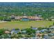 Aerial perspective showcasing the impressive clubhouse, pool area, and meticulously maintained grounds at 172 Balmy Coast Rd, Groveland, FL 34736