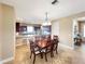 Cozy dining area adjacent to the kitchen with a stylish chandelier and comfortable seating for Gathering meals at 172 Balmy Coast Rd, Groveland, FL 34736