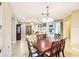 Open dining area leading to a bright living room, with views of the cozy fireplace, creating an inviting space at 172 Balmy Coast Rd, Groveland, FL 34736