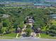 Aerial view of the community entrance featuring lush landscaping and the community's name, Trilogy, prominently displayed at 172 Balmy Coast Rd, Groveland, FL 34736