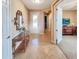 Well-lit entryway showcasing tiled floors, console table and access to various rooms at 172 Balmy Coast Rd, Groveland, FL 34736