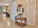 Inviting foyer featuring a decorative table, mirror, and view into the dining room at 172 Balmy Coast Rd, Groveland, FL 34736