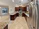 This is a spacious kitchen that features dark wood cabinets, granite countertops, and stainless steel appliances at 172 Balmy Coast Rd, Groveland, FL 34736