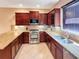 Modern kitchen featuring granite countertops, stainless steel appliances, and ample cabinet space for culinary enthusiasts at 172 Balmy Coast Rd, Groveland, FL 34736