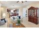 Inviting living room featuring neutral tones, tile floors, and comfortable seating, seamlessly flowing into the kitchen at 172 Balmy Coast Rd, Groveland, FL 34736