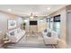 Bright living room with neutral tones, large windows, and stylish furniture at 172 Balmy Coast Rd, Groveland, FL 34736