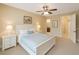 Serene main bedroom featuring soft colors, a ceiling fan, and an ensuite bathroom at 172 Balmy Coast Rd, Groveland, FL 34736