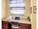 Office nook with granite desktop, chair, laptop, printer, blue nautical-themed curtains at 172 Balmy Coast Rd, Groveland, FL 34736