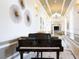 Spacious piano room with a grand piano, chandelier lighting and elegant decor at 172 Balmy Coast Rd, Groveland, FL 34736