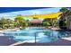 Large community pool featuring many lounge chairs and beautiful lush tropical landscaping at 172 Balmy Coast Rd, Groveland, FL 34736