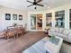 Relaxing sunroom featuring neutral furnishings, ceiling fan and sliding doors to the outdoors at 172 Balmy Coast Rd, Groveland, FL 34736