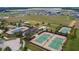 Aerial view showcasing the community's tennis courts, bocce ball, and surrounding greenery at 172 Balmy Coast Rd, Groveland, FL 34736