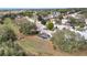 Aerial view of home showcasing backyard with screened pool and surrounding neighborhood at 1739 Nectarine Trl, Clermont, FL 34714