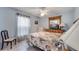 Cozy bedroom featuring a ceiling fan, TV, and a unique floral-themed bedspread at 1739 Nectarine Trl, Clermont, FL 34714