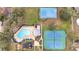 Aerial view of community pool, tennis courts, playground, and common areas at 1739 Nectarine Trl, Clermont, FL 34714