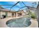 Beautiful screened-in pool area with lounge chairs, a dining table, and lush landscaping at 1739 Nectarine Trl, Clermont, FL 34714