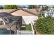 View of the home's pool, screened enclosure, and adjacent outdoor patio at 1739 Nectarine Trl, Clermont, FL 34714