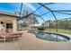 Relaxing screened-in pool with an outdoor lounging area overlooking a well-maintained backyard at 1739 Nectarine Trl, Clermont, FL 34714