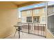 Private balcony with a wrought iron railing offers community views and a bistro table at 2041 Lobelia Dr, Lake Mary, FL 32746