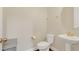 Powder room featuring a pedestal sink, toilet, and gold fixtures at 2041 Lobelia Dr, Lake Mary, FL 32746