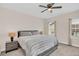 Cozy bedroom with a ceiling fan, a plush bed, carpet, and natural light streaming through the windows at 2041 Lobelia Dr, Lake Mary, FL 32746