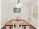 Dining room features a wooden table, four chairs, and a window with blinds at 2041 Lobelia Dr, Lake Mary, FL 32746