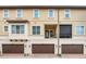 Exterior of townhome showcasing private balconies and garages with carriage-style doors at 2041 Lobelia Dr, Lake Mary, FL 32746