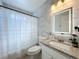 Updated bathroom featuring stylish granite countertop, modern vanity, and decorative mirror at 2229 Churchill Downs Cir, Orlando, FL 32825