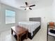 Comfortable bedroom with a ceiling fan and a gray tufted headboard at 2229 Churchill Downs Cir, Orlando, FL 32825