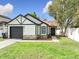 Charming single-Gathering home with a well-manicured lawn, black trim and an attached garage at 2229 Churchill Downs Cir, Orlando, FL 32825