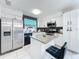 Modern kitchen with stainless steel appliances, an island, and black and white backsplash at 2229 Churchill Downs Cir, Orlando, FL 32825