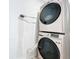 Close-up of a stacked washer and dryer unit in a laundry area at 2229 Churchill Downs Cir, Orlando, FL 32825