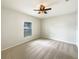 Bedroom with neutral walls, carpet, and a window with blinds to allow natural light at 240 Whispering Pines Way, Davenport, FL 33837