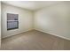 Carpeted bedroom with neutral walls, carpet, and a window with blinds to allow natural light at 240 Whispering Pines Way, Davenport, FL 33837