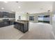 Modern kitchen featuring dark cabinetry, a breakfast bar, tile flooring and stainless steel appliances at 240 Whispering Pines Way, Davenport, FL 33837