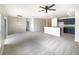 Open living room area featuring plush carpeting, a ceiling fan, and sliding glass doors to the outside at 240 Whispering Pines Way, Davenport, FL 33837